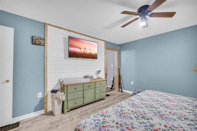 bedroom featuring ceiling fan and light hardwood / wood-style flooring