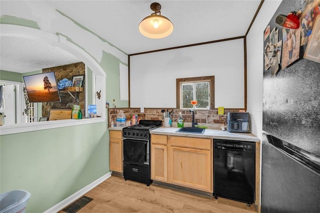 kitchen featuring sink, backsplash, black appliances, light hardwood / wood-style floors, and light brown cabinets