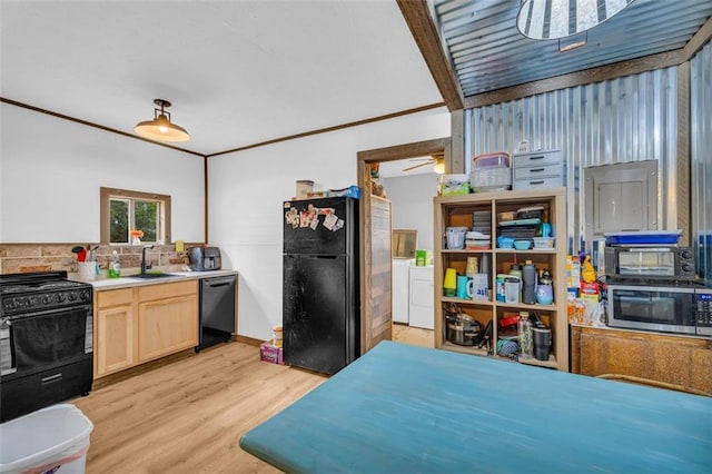 kitchen with light brown cabinetry, sink, separate washer and dryer, light wood-type flooring, and black appliances