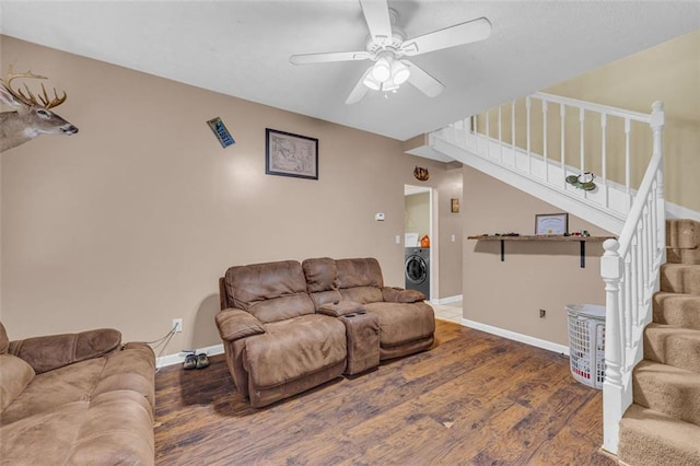 living room with washer / clothes dryer, ceiling fan, and dark hardwood / wood-style flooring