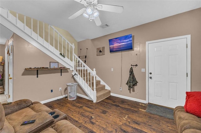 living room featuring ceiling fan and dark hardwood / wood-style floors