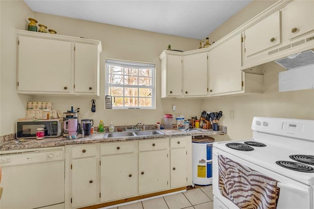 kitchen featuring light tile patterned flooring, white appliances, and sink