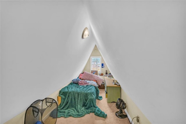 bedroom featuring carpet and lofted ceiling