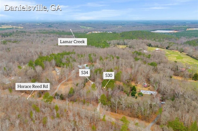 birds eye view of property with a rural view