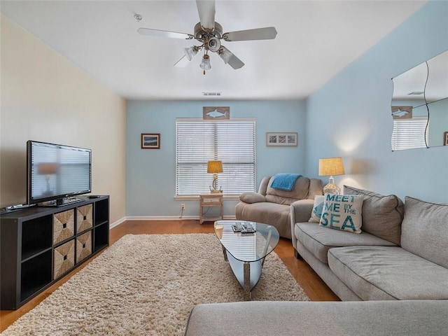 living room featuring hardwood / wood-style floors and ceiling fan