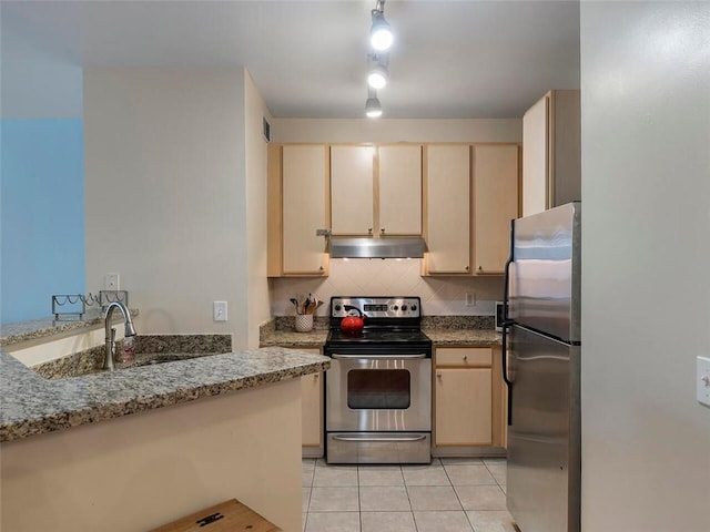 kitchen with light stone counters, light tile patterned floors, light brown cabinetry, and appliances with stainless steel finishes