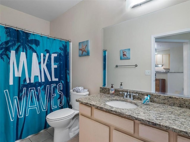 bathroom featuring tile patterned flooring, vanity, and toilet