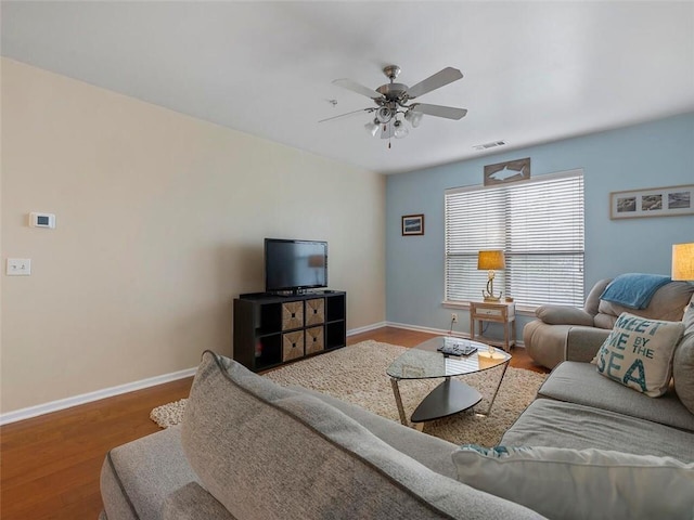 living room featuring ceiling fan and hardwood / wood-style flooring