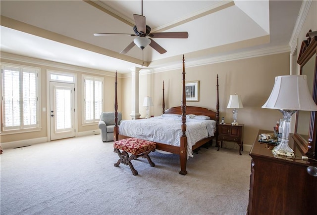 bedroom with light carpet, ornamental molding, ceiling fan, and a tray ceiling