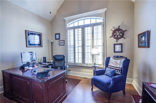 home office featuring lofted ceiling, dark hardwood / wood-style flooring, and a wealth of natural light