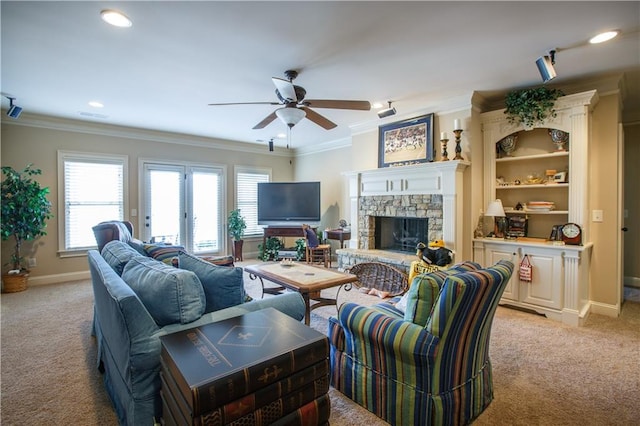 living room with ceiling fan, a fireplace, crown molding, french doors, and light colored carpet