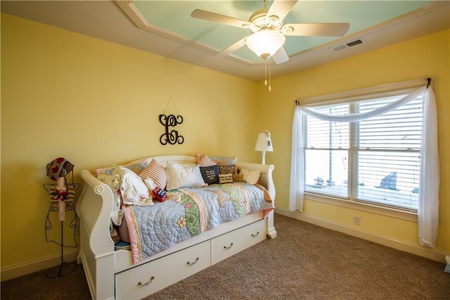 bedroom with ceiling fan and dark colored carpet