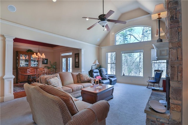 living room featuring carpet flooring, high vaulted ceiling, ceiling fan with notable chandelier, and decorative columns