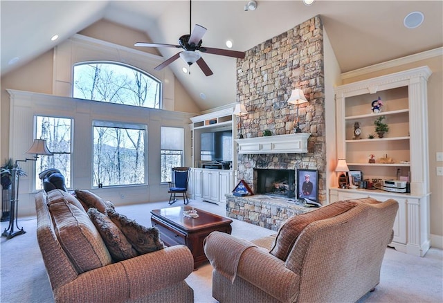 living room featuring light carpet, a stone fireplace, ceiling fan, and high vaulted ceiling