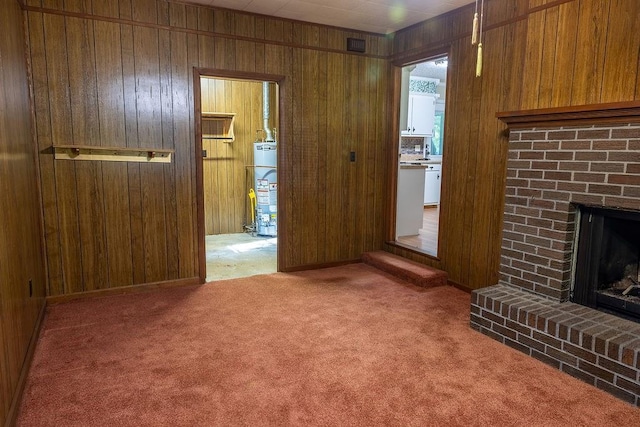 4370 Tradition Ter, Austell, GA 30106 - unfurnished living room with water heater, wooden walls, a fireplace, and carpet floors