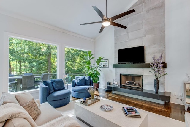6144 Scott Dr, Flowery Branch, GA 30542 - living area with lofted ceiling, a ceiling fan, a tile fireplace, crown molding, and wood finished floors