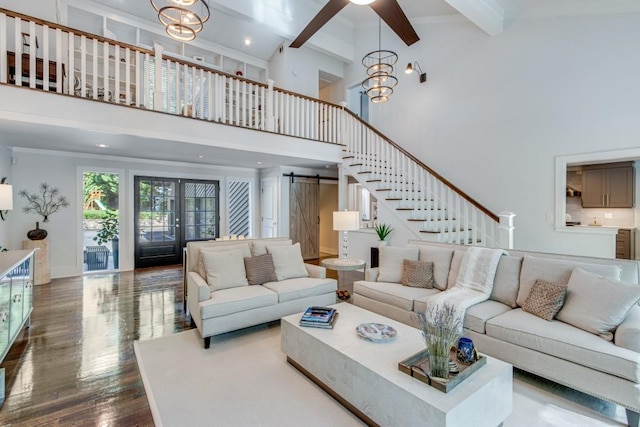 6144 Scott Dr, Flowery Branch, GA 30542 - living room with a barn door, a towering ceiling, beamed ceiling, dark wood-type flooring, and stairs