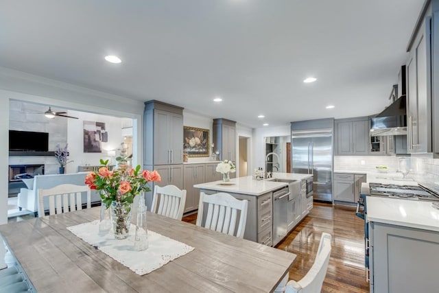 6144 Scott Dr, Flowery Branch, GA 30542 - dining area featuring ceiling fan, dark wood-style floors, ornamental molding, a premium fireplace, and recessed lighting