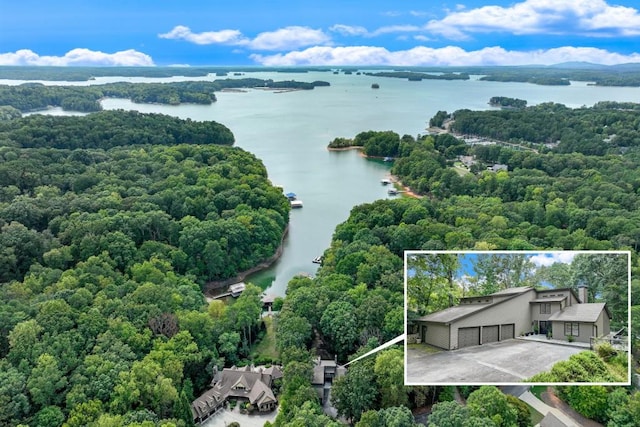 aerial view with a forest view and a water view