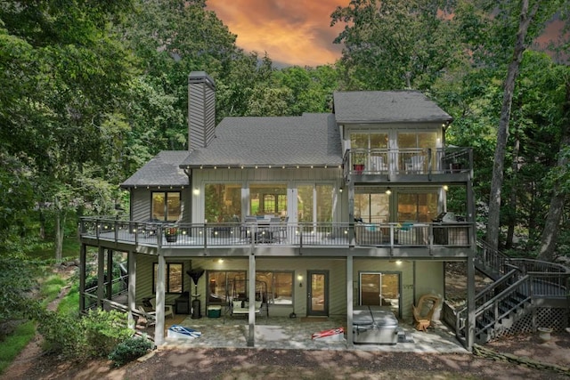 6144 Scott Dr, Flowery Branch, GA 30542 - back of property with a patio area, a shingled roof, a balcony, stairway, and a chimney