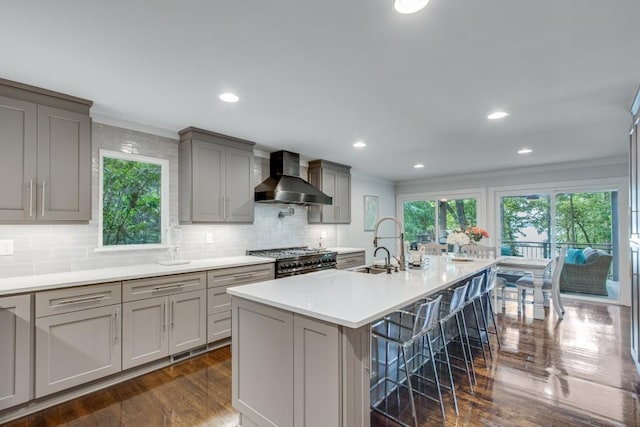 6144 Scott Dr, Flowery Branch, GA 30542 - kitchen featuring wall chimney exhaust hood, gray cabinetry, stainless steel stove, a sink, and ornamental molding
