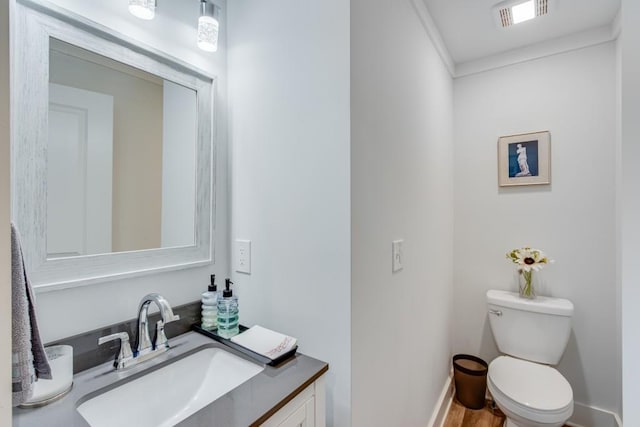 6144 Scott Dr, Flowery Branch, GA 30542 - half bathroom featuring toilet, vanity, baseboards, and ornamental molding