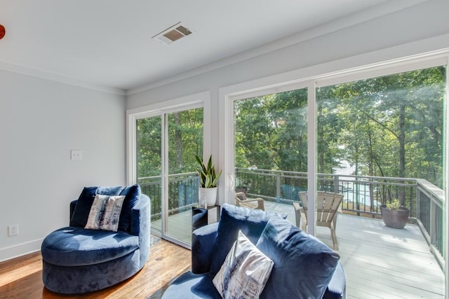 6144 Scott Dr, Flowery Branch, GA 30542 - living area featuring wood finished floors, crown molding, and baseboards