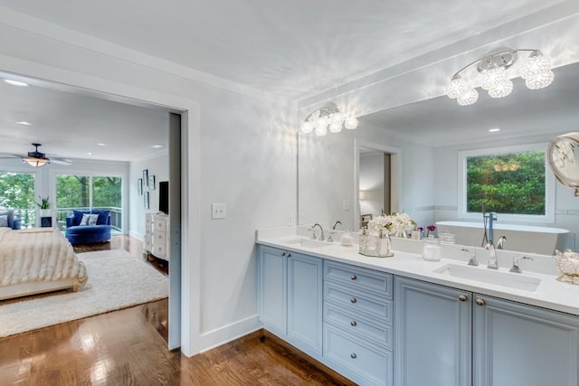 6144 Scott Dr, Flowery Branch, GA 30542 - bathroom featuring a chandelier, a ceiling fan, double vanity, ensuite bath, and a freestanding tub