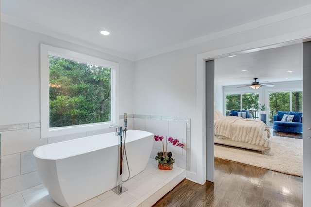 6144 Scott Dr, Flowery Branch, GA 30542 - full bath featuring tile walls, plenty of natural light, ensuite bath, a freestanding tub, and wood finished floors