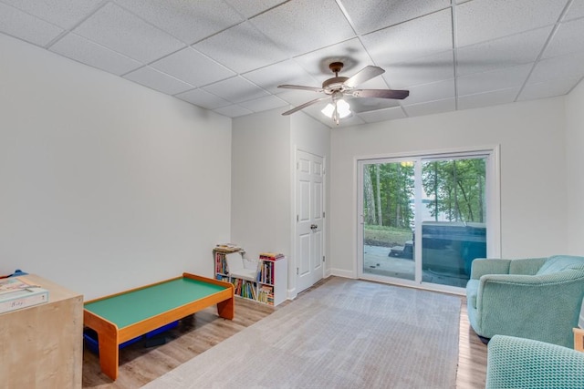 6144 Scott Dr, Flowery Branch, GA 30542 - recreation room featuring wood finished floors, a drop ceiling, a ceiling fan, and baseboards