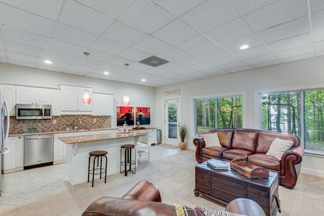6144 Scott Dr, Flowery Branch, GA 30542 - living area featuring a paneled ceiling and light carpet