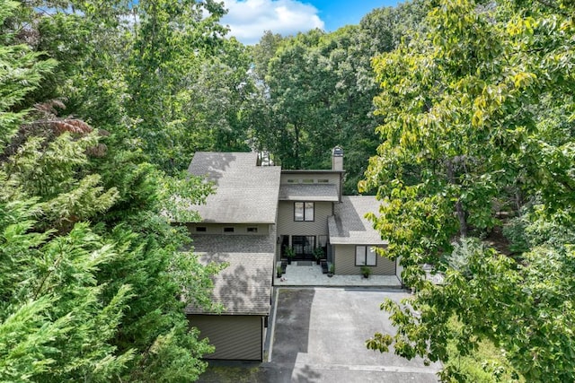 6144 Scott Dr, Flowery Branch, GA 30542 - view of front of property with a chimney, a shingled roof, brick siding, and driveway