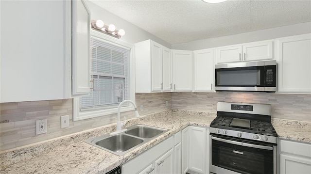 6964 Oakhill Cir, Austell, GA 30168 - kitchen with appliances with stainless steel finishes, a sink, white cabinets, a textured ceiling, and tasteful backsplash