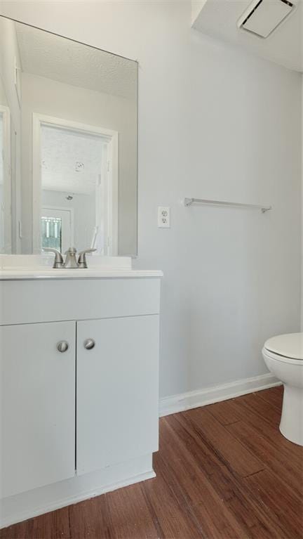 6964 Oakhill Cir, Austell, GA 30168 - bathroom featuring vanity, baseboards, wood finished floors, and toilet