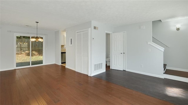 6964 Oakhill Cir, Austell, GA 30168 - unfurnished living room with a chandelier, dark wood-type flooring, and baseboards