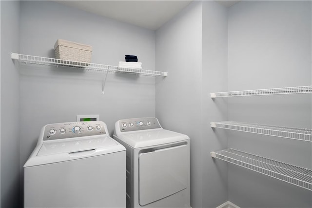 laundry room with washing machine and clothes dryer