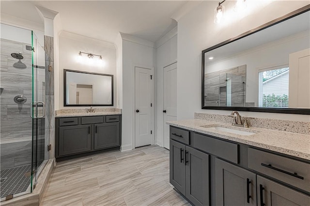 bathroom featuring crown molding, vanity, and a shower with shower door