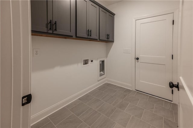 washroom with electric dryer hookup, cabinets, light tile patterned floors, and hookup for a washing machine