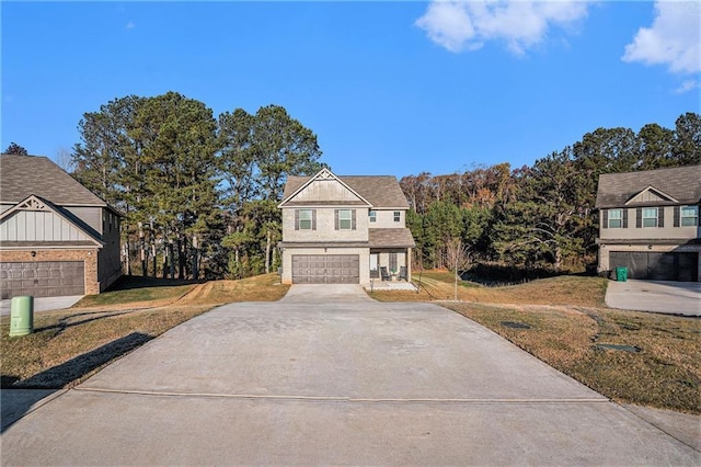 view of front of property with a garage and a front lawn