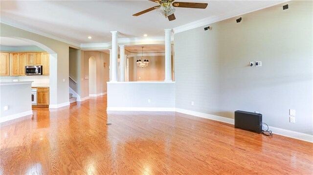 5345 Glenhaven Dr, Cumming, GA 30041 - unfurnished living room with ornamental molding, a ceiling fan, arched walkways, light wood-type flooring, and recessed lighting