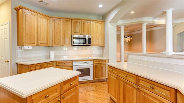 5345 Glenhaven Dr, Cumming, GA 30041 - kitchen featuring stainless steel microwave, white oven, decorative columns, tasteful backsplash, and light countertops