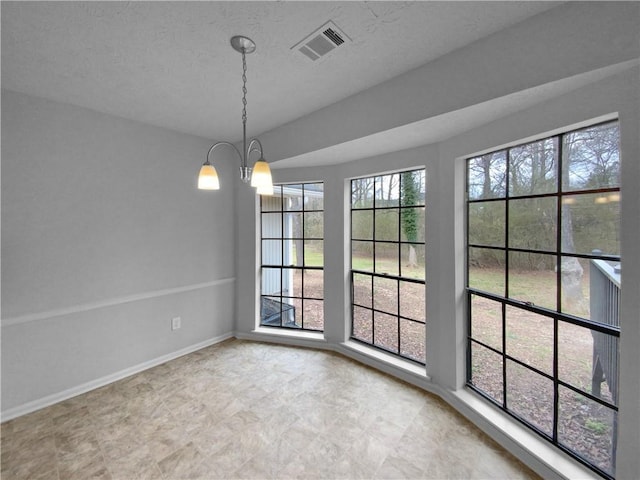 unfurnished dining area with a chandelier