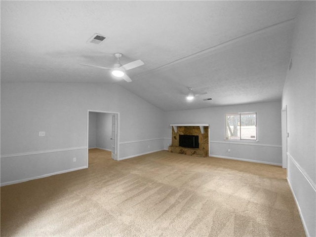 unfurnished living room featuring ceiling fan, light colored carpet, lofted ceiling, and a fireplace