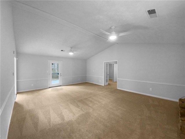 interior space with ceiling fan, lofted ceiling, and carpet floors