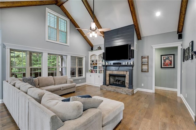 7269 Tyree Rd, Winston, GA 30187 - living room with high vaulted ceiling, ceiling fan, beam ceiling, a brick fireplace, and wood finished floors