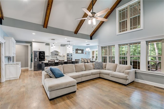 7269 Tyree Rd, Winston, GA 30187 - living room with high vaulted ceiling, light wood finished floors, a ceiling fan, beamed ceiling, and recessed lighting