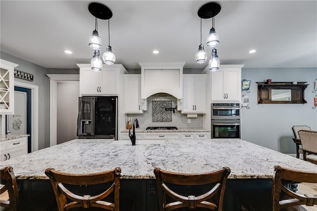 7269 Tyree Rd, Winston, GA 30187 - kitchen featuring refrigerator with ice dispenser, stainless steel double oven, white cabinets, tasteful backsplash, and recessed lighting