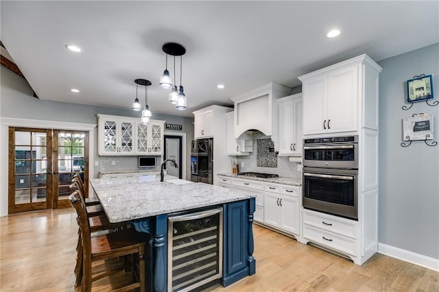 7269 Tyree Rd, Winston, GA 30187 - kitchen featuring beverage cooler, stainless steel double oven, gas stovetop, white cabinetry, and recessed lighting