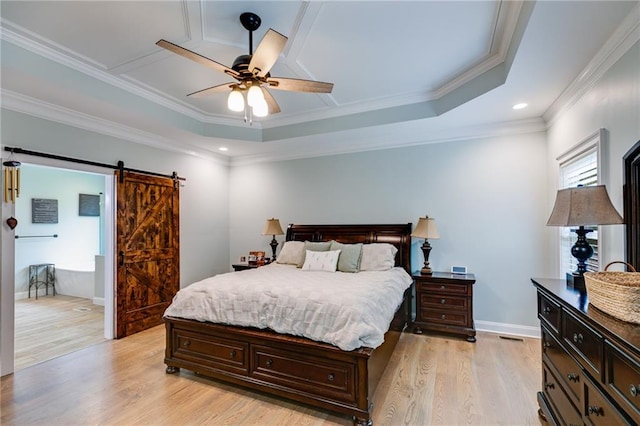 7269 Tyree Rd, Winston, GA 30187 - bedroom with light wood-style flooring, a barn door, a raised ceiling, recessed lighting, and ornamental molding