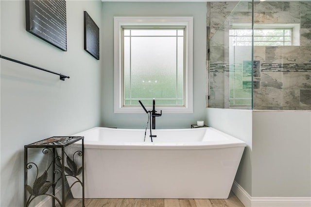 7269 Tyree Rd, Winston, GA 30187 - full bathroom featuring a freestanding bath, wood finished floors, and tiled shower